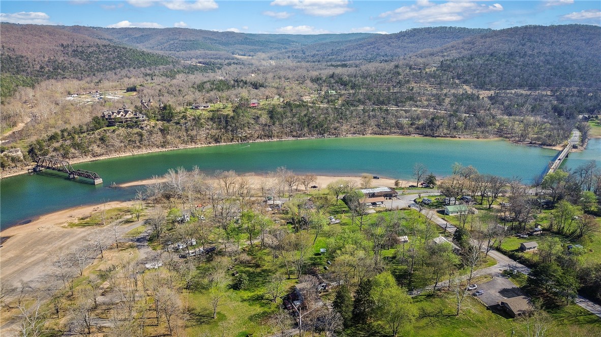 Nestled on 1.27 private acres in the beautiful Beavertown area of Eureka Springs, this charming 2-bedroom, 2-bathroom home offers 1,070 square feet of comfortable living space with easy access to Beaver Lake and stunning lake views. A standout feature is the detached garage with a fully finished 352-square-foot studio apartment above it, currently tenant-occupied and ideal for generating additional rental income (main home is also tenant-occupied). Located near the iconic Eureka Springs swinging bridge, this property combines privacy, natural beauty, and strong investment potential. Perfect as a primary residence, weekend getaway, or income-producing opportunity in one of Northwest Arkansas’s most desirable lake areas.