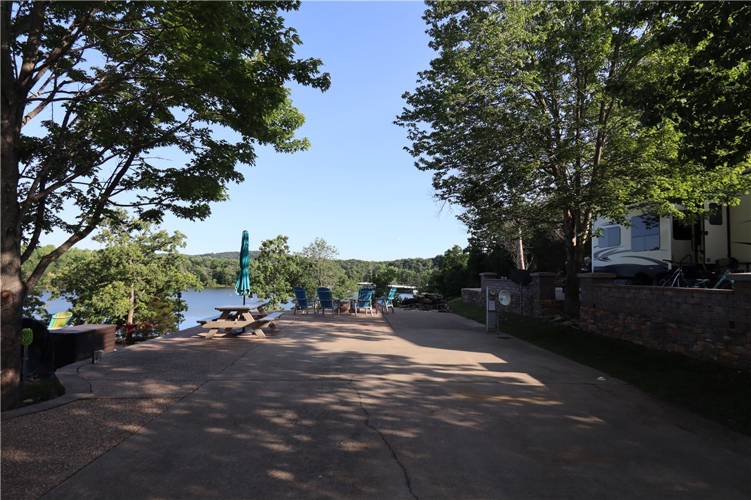 Lakefront RV Lot in Ozarks RV Resort on Table Rock Lake!

This lot boasts stunning lakefront views, creating a peaceful and picturesque setting. A beautiful stone waterfall adds to the natural charm and enhances the relaxing atmosphere. Outdoor amenities include a Breeo stone firepit for roasting marshmallows or hot dogs, and a durable poly picnic table with umbrella for splinter-free, low-maintenance outdoor meals in some shade. Perfect for gatherings and unwinding, the space also features a barbecue grill. The resort operates seasonally, closing from December to February, with no full-time living allowed—though RVs may stay during the off-season. An HOA/POA covers amenities like road maintenance, basketball, tennis/pickleball courts, pools for owners and guests, waterfalls throughout the property, laundry facilities, and a disc golf course. Seller is Owner/Agent.