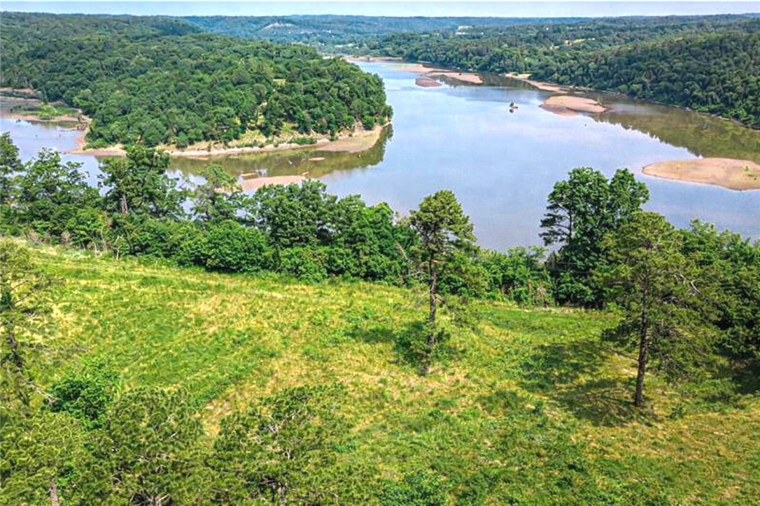 Beaver Lake front/view! This breathtaking property boasts 365.26 feet of lake frontage. Hunters and nature lovers escape! Enjoying stunning sunsets, fishing, deer hunting, abundant wildlife, and endless outdoor adventures, everything right on your own land.Seller has heard year round springs and a small cave, but these have not yet been professionally verified.Despite its peaceful seclusion, in 32 minutes you can be in downtown Rogers, Fayetteville, and Springdale, where you’ll find restaurants, shopping, and entertainment. No deed restrictions—giving you the freedom to build and enjoy as you wish. Beauty awaits you as you build your dream home retreat! Old house was demolished at 2023. Electric meter was removed, but can be replaced 24 hours.There is a  work shop approximately 2000 SQFT on site.