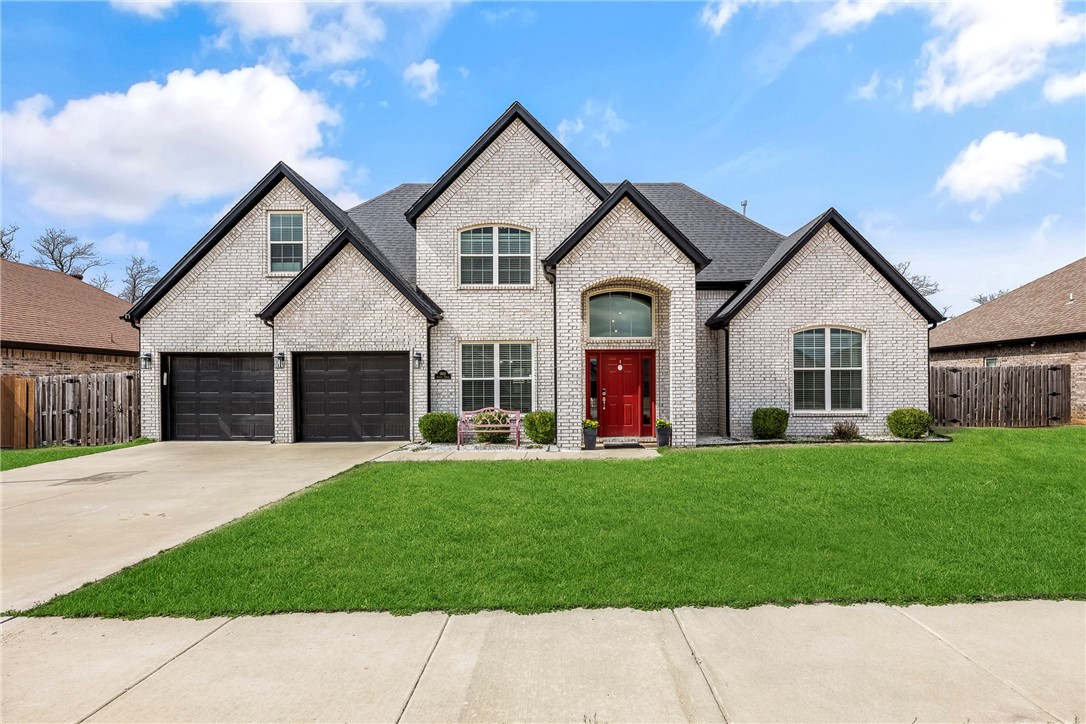 Searching for a 4-bed home near Bentonville schools with modern upgrades just 15 minutes from downtown Bentonville? This beautifully built brick home offers 2,381 sq. ft. of thoughtfully designed living space on a 0.25-acre lot. The living room impresses with a soaring cathedral ceiling, gas log fireplace, and seamless flow into the dining and kitchen areas—perfect for everyday living and entertaining. The kitchen features stainless steel appliances, a 5-burner gas range, soft-close cabinetry, and a generous pantry. The main-level primary suite includes dual vanities, dual walk-in closets, a whirlpool tub, and walk-in shower. Upstairs bedrooms offer cathedral ceilings, walk-in closets, and access to two walk-in attic storage areas. Smart upgrades include Ring security and Nest thermostats. Enjoy a covered patio with ceiling fan and TV, gas firepit, fenced yard, and 10x10 shed. Several items convey (see feature list).