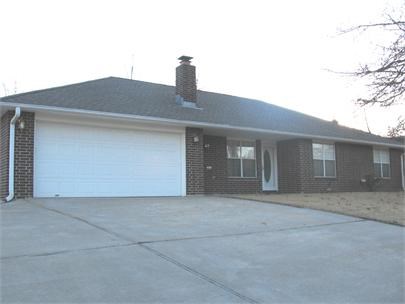 Charming 3 bed, 2 bath single family home in established neighborhood just minutes from I-49, schools, shopping and restaurants. Large open kitchen w/full-size fridge, gas cook stove, and dishwasher. Kitchen has tile countertops, lots of oak cabinets for storage, breakfast counter overlooks living room. Brick gas fireplace. Built-in cabinets throughout. Laundry has washer/dryer hookups. Ceiling fans and blinds. Vinyl plank in living room/hall. Storage unit. Mature trees. 2-car garage w/expanded driveway. Pets negotiable. Tenant occupied until 7/31/26.