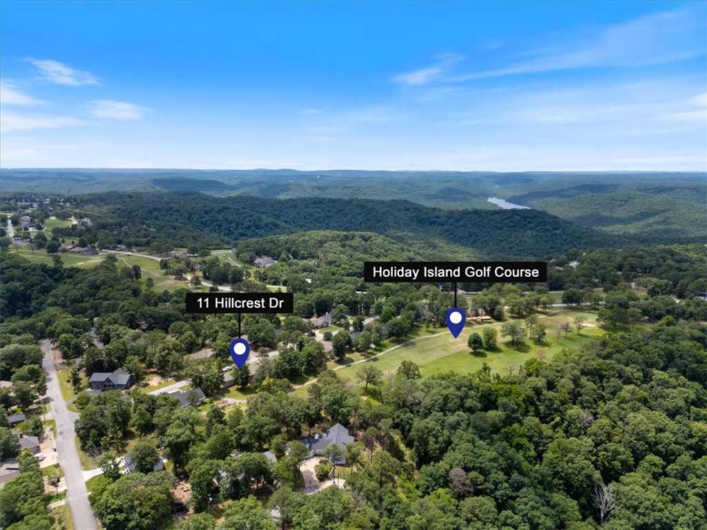 Quality lake area home with 2 large primary suites located on the 4th Fairway of the Holiday Island 18 hole golf course. This well maintained home is perfectly located just minutes from Table Rock Lake and the Holiday Island Marina. You can golf in the morning and fish in the afternoon! Lake life is the GOOD LIFE! The floor plan of this home is perfect, allowing each primary suite to have complete privacy while both have their own deck areas accessible from their room as well as a third deck entrance from large glass french doors in the living room. Shout out to the family chef, you are going to love this kitchen. It is perfect for entertaining family and friends. The open concept kitchen, dining and living area make this home feel very expansive. The high ceilings and multitude of large windows give the space a light and airy feel. The large garage lends itself to be multi-functional. You could make a small workshop space and store all the lake toys, boat, golf cart and truck...yes it is deep enough for the truck!