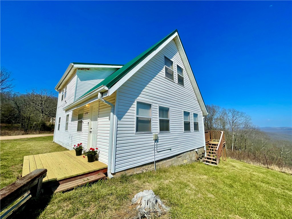 VIEWS!! Vacation calling your name?This has it all with a captivating drive to start with, gorgeous VIEWS of the Ozarks,War Eagle flowing on each side of the hwy to crossing a bridge over Seals Creek leading you to relax on your expansive deck with long beautiful views.You will not want to leave.Sold 'As-Is'.Existing well has collapsed.**Sellers to credit $5,000 toward well/closing cost with acceptable offer**Fully self-sufficient, this home uses a stored water system that easily supports 2 occupants for over a week. Buyer to take responsibility for drilling a new well or restoring the existing water source. 3bed/2bath, all electric, 2 yr old metal roof, New Fridge.New energy eff washer/dryer.Note that the oven is currently out of order though the stove top works.18x20 outbuilding. 20x20 storage building.The adjoining 23 acres is for sale see MLS# 1342544.Offers great hunting,hiking,camping,riding, & exploring with multiple wet weather creeks/streams traversing the property! Invest in both,escape to the Ozarks!