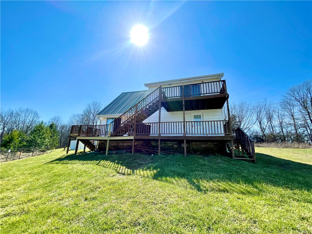 VIEWS, VIEWS, VIEWS!! Vacation calling your name? This has it all with a captivating drive to start with, gorgeous views of the Ozarks, War Eagle flowing on each side of the hwy to crossing a bridge over Seals Creek leading you to relax on your expansive deck with long beautiful views. You will not want to leave. Sold 'As-Is'. Existing well has collapsed. Fully self-sufficient, this home uses a stored water system that easily supports two occupants for over a week. Buyer to take responsibility for drilling a new well or restoring the existing water source. 3bed/2bath, all electric, 2 yr old metal roof, New Fridge. New energy eff washer/dryer. Note that the oven is currently out of order though the stove top works. 18x20 outbuilding. 20x20 storage building. The adjoining 23 acres is for sale see MLS# 1342544. Offers great hunting, hiking, camping, riding, & exploring with multiple wet weather creeks/streams traversing the property! Invest in both, escape to the Ozarks!