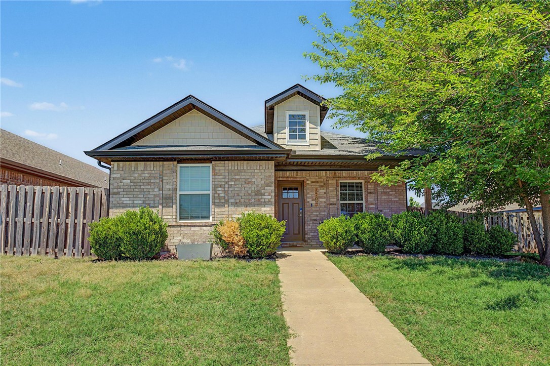 Welcome to a well-maintained all-brick home, ideally offering convenient access to the new 8th Street Gateway Park, 3.5 miles from the Walmart Home Office, and is in close proximity to trails and schools. With an expanded and fully fenced side yard, and the newest home on the street, this property combines space and functionality. Inside, the home features a seamless open layout with vaulted ceilings in the living room, tile flooring throughout the main living spaces, and a split floor plan. The spacious fenced backyard provides exceptional outdoor space, while the extended concrete patio creates the perfect setting for entertaining and gathering. Additional highlights include an updated dormer window for enhanced curb appeal and a rear-entry two-car alley garage. Currently operating as a successful short-term rental, this home is ideal for first-time buyers, investors, or those seeking a move-in ready property in a highly convenient Bentonville location. Furnishings may convey with an acceptable offer.