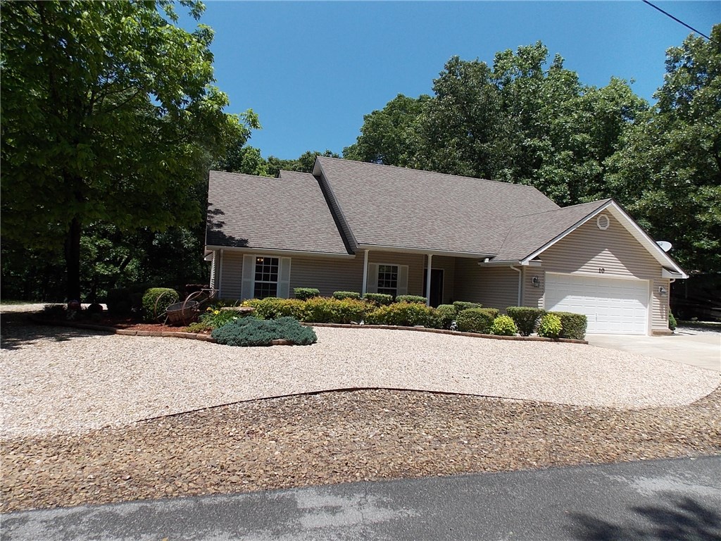 Wonderful Home! Shows like new! Large kitchen with sitting area. Property includes large lot north of the home.  Both lots are level. New wood floors in living room and hall. 12 x 20 Extra garage. This home is a must see. Wood blinds convey.  Deck has power awning. 2 bedroom septic. but with 1000 gal tank.