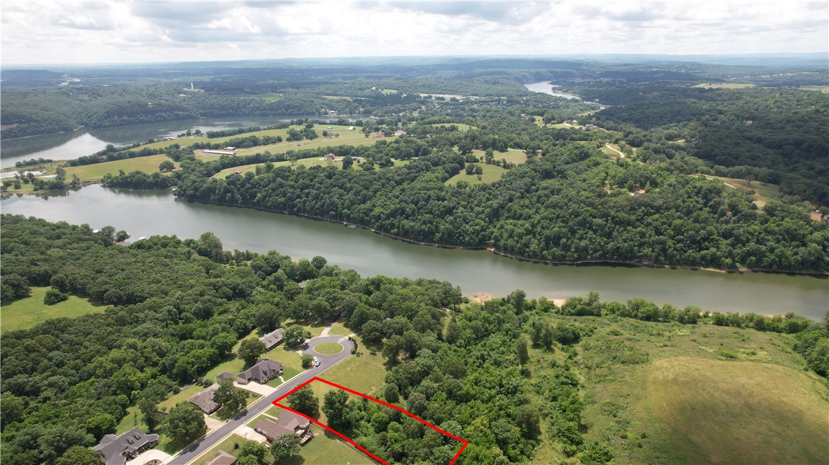 Build your dream home in one of the Beaver Lake/White River area’s most scenic lake communities. This beautiful lot offers exceptional views and is located in a peaceful cul-de-sac neighborhood with community lake access and a boat launch. Enjoy the perfect balance of tranquility and convenience, with grocery stores, restaurants, and schools all within a 20-minute drive. The property also offers excellent proximity to the future bypass expansion, providing enhanced access throughout Northwest Arkansas and adding to its long-term appeal. Lateral lines from Lot 15 extend into the building setback/utility easement located toward the rear of the property. Come experience the beauty and potential this property has to offer.