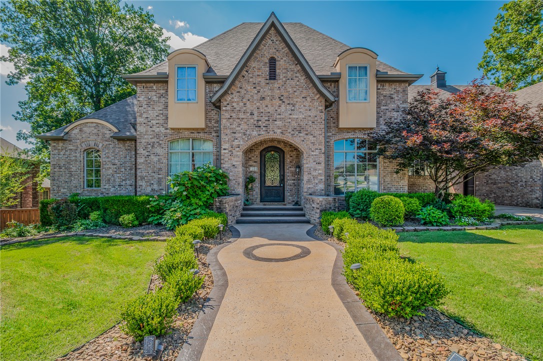 Discover comfortable elegance at 1504 Chapel Hill Drive, ideally located within minutes of everything Bentonville has to offer. Built in 2008 and meticulously maintained by its original owner, this impressive 5,033 sq. ft. custom home was designed for both everyday living and effortless entertaining. Featuring four spacious bedrooms, including a primary bedroom and a guest suite on the main level, the flexible floor plan offers comfort and privacy for family and guests alike. Exceptional storage sets this home apart, with custom cabinetry, oversized walk-in closets in every bedroom, a walk-out attic, an unfinished basement space, and countless organizational features throughout. Expansive living areas, natural light, and timeless finishes create a warm, inviting atmosphere. Unwind in the beautiful glass-enclosed patio overlooking a serene Italian-inspired rock garden. This one-of-a-kind, exceptional property offers a rare opportunity to enjoy refined living in one of Northwest Arkansas's most desirable locations.