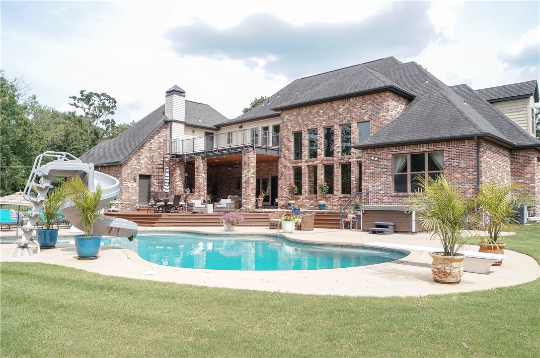 First Time Ever on the Market! Welcome to 6006 W. Kennedy Drive in Fayetteville—a rare one-owner custom estate offering approximately 5,300 sq. ft. on 1.7 beautifully maintained acres. Built in 2010, this 5-bedroom, 4.5-bath home features an open-concept design with soaring 23-foot ceilings, abundant natural light, and exceptional craftsmanship throughout. The main level includes a dedicated office and a luxurious primary suite with separate his-and-her closets. Upstairs, enjoy a media room perfect for family entertainment. The vaulted game room boasts a wood-burning fireplace, wet bar, and ample space for gatherings. Outside, a covered patio with a second fireplace overlooks the resort-style backyard featuring a 40,000-gallon saltwater pool, hot tub, mature landscaping, Zoysia grass, and underground dog fence. A truly exceptional Fayetteville property offering luxury, privacy, and unmatched amenities.