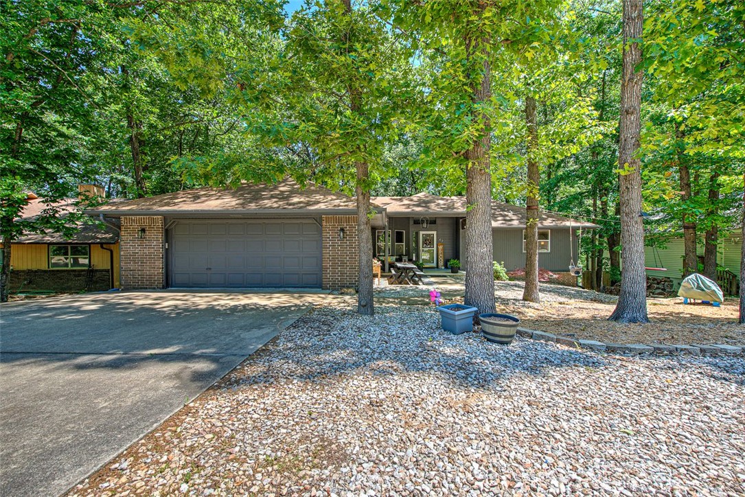 Now available—bring your vision and make this home your own! Recent updates include brand new carpet in the living room and bedrooms, stylish LVP flooring in the kitchen and master bath, and fresh paint throughout. 
The spacious living room features a cozy fireplace and soaring cathedral ceiling with exposed beams. Enjoy both a formal dining area and an eat in kitchen, screened in porch, perfect for everyday living and entertaining. The master suite offers a large walk in closet, and the split bedroom layout provides added privacy.
Additional highlights include an outbuilding for extra storage, plus a large lower-level workshop/workout room with exterior access—ideal for projects or hobbies. A fenced backyard completes the package, and bike trails just down the street make this home a great fit for outdoor enthusiasts. New HVAC 2025, Carpet flooring 2023.