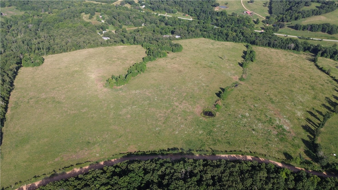 Beautiful rolling acreage offering the perfect blend of open pasture, mature timber, and privacy just minutes from Huntsville. This versatile property features multiple scenic building sites, a pond, and a mix of cleared ground ideal for cattle, horses, or hobby farming. The wooded acreage provides excellent wildlife habitat with abundant deer and turkey, making it equally appealing for recreation and hunting. A private drive and county road access offer convenient entry while maintaining a peaceful country setting. Whether you’re looking to build your dream home, create a family farm, establish a weekend retreat, or invest in Northwest Arkansas land, this property offers endless possibilities. Enjoy the tranquility of rural living with the convenience of being a short drive from Huntsville and the amenities of Northwest Arkansas. Rare opportunity to own a beautiful, multi-use tract in a highly desirable area.