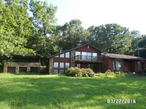 This is a unique country charmer with a beautiful view. Lots of beautiful rock work, large windows, claw foot bathtub, beautiful landscaped stone work walls and terraces. Antique European mantel and spacious sitting room. All of this on over 5 acres M/L and a includes a large shop building. This is a one of a kind home just needing a little TLC to restore it to it's former glory.