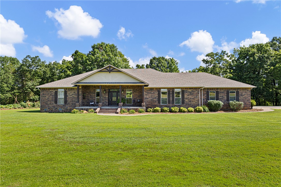 Set on more than 19 acres, this one-of-a-kind property offers an exceptional blend of natural beauty and your own private recreational retreat. The moment you step through the front door, your eye is drawn to the expansive rear windows framing the stunning view where McCoy Creek and Gum Creek meet—an ever-changing, serene backdrop best enjoyed from the covered back porch.
The property features a versatile barn perfect for equipment storage or hobby use.  An inviting 1,200 sq. ft. pool/guest house—complete with a full kitchen, bathroom, and additional bedroom—which makes hosting effortless. The in-ground pool provides a peaceful place to unwind, surrounded by wide-open skies and quiet rural scenery. A scenic, stocked pond further enhances both the beauty and recreational appeal of the land.
Here, you truly get the best of both worlds: tranquil rural living with the convenience of town just minutes away.
