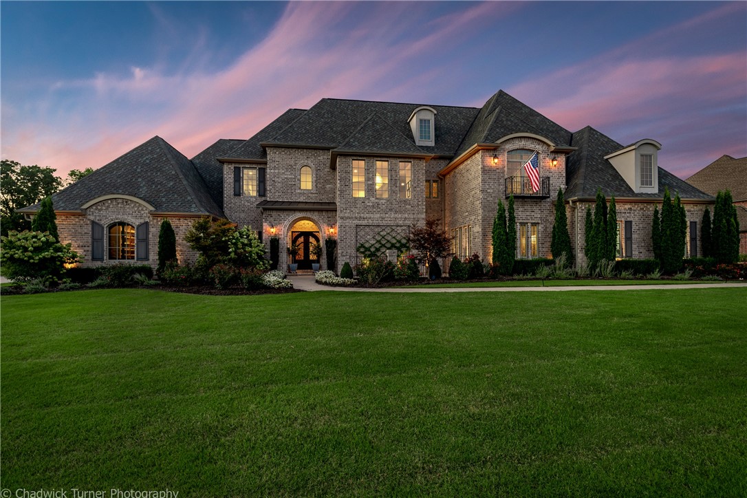 Stunning custom built home boasting all the amenities you desire! This contemporary beauty was featured as a Parade of Homes Showcase Home. The soaring ceilings and massive windows capture the private view. Sitting on 1.88 acres the outdoor space is inviting and beautiful with two covered patio areas perfect for relaxing or outdoor entertainment. The kitchen is a chef's dream with multiple workspaces and an impressive Bertazzoni Heritage range! The master suite feels like a luxury hotel space with fabulous master bathroom. Stunning office with fireplace, guest suite on main level, formal dining room, mud room on main level with upstairs featuring movie theater room, bedrooms, large living space and built-in office upstairs. There is a patio outside the living room perfect to enjoy the scenery. Updates throughout and impressive architectural design create a home you'll want to call your own!