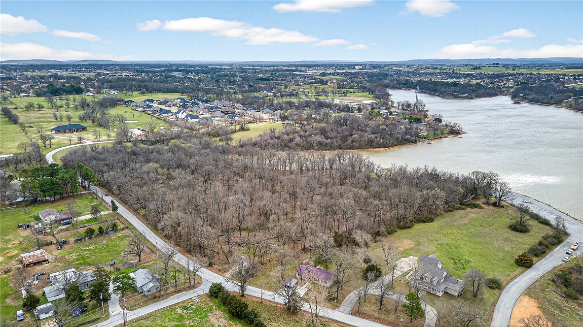 Discover the rare opportunity to own lakefront land on beautiful Lake Elmdale in Elm Springs. This scenic property offers the perfect balance of peaceful nature and everyday convenience, with easy access to I-49 and all that Northwest Arkansas has to offer. Imagine designing and building your dream custom home surrounded by tranquil water views, mature trees, and the quiet charm of lakeside living. Whether you're looking for a private estate or a development opportunity, the possibilities here are exceptional. Purchase the entire parcel for a spacious retreat, or take advantage of the potential lot split into four homesites—ideal for custom builds or investment. Opportunities like this don’t come along often. Lots are subject to lot split. Prelimary lines are shown- survey would need to be completed and formal process filed. Individual Lots 1, 2, 3, & 4 are available, each approximately 2.38 acres. Reference MLS #1338315, #1338403, #1338411, and #1338416.
