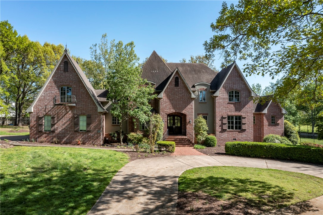 Executive Custom-Built European Estate on 4 acres in the heart of Rogers! Located minutes from the Pinnacle Promenade, this private estate home provides a quiet serene setting yet minutes from everything! House sets back nestled on secluded wooded lot with beautiful mature trees! Gourmet kitchen, hardwood floors, 3 fireplaces, media/bonus room 2 bedrooms on the main level including and a grand Master Suite with his & her private baths and private office.  Tons of storage and lot of custom details throughout.  Expansive back covered porch to enjoy the private backyard setting. Must see to appreciate all this home has to offer and potential of putting your own personal touches on it making it your own private estate!