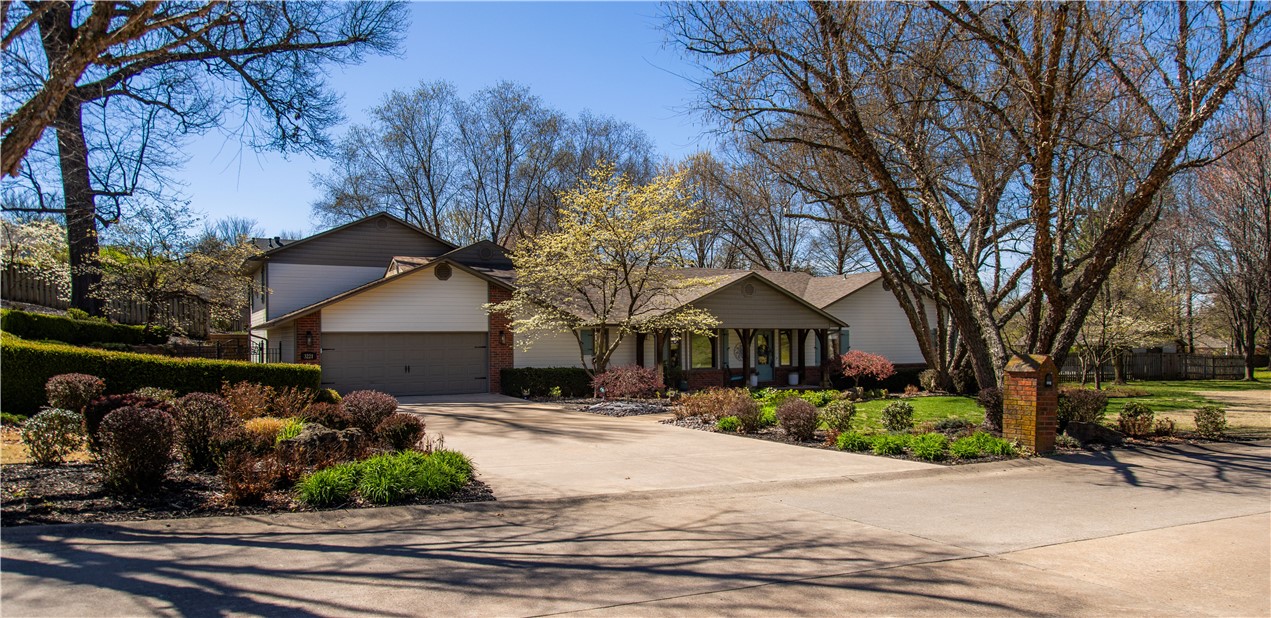 Welcome to your dream oasis nestled on nearly an acre of lush landscape! This magnificent estate boasts 5 bedrooms, 4.5 baths, & an array of living spaces including living room full of natural light, well-appointed kitchen, formal dining, study, plus versatile game room & den. Primary suite offers sitting area, en suite bath, & access to outdoors. Spacious utility features sink & pass-through cabinetry, ideal for keeping essentials easily accessible. Retreat to upstairs great room for leisure time or relaxation. Enhanced with 3 indoor fireplaces & abundant built-ins, every corner exudes warmth & character. Outside, discover a resort-style haven featuring a pool, complete with slide & diving board, and a charming pool house with full bath & storage with overhead door. As the sun sets, gather around the cozy outdoor stone fireplace or indulge in the inviting hot tub. With open-air sitting areas thoughtfully scattered throughout the botanical garden-like yard, you'll find plenty of spaces to unwind & soak in serenity.