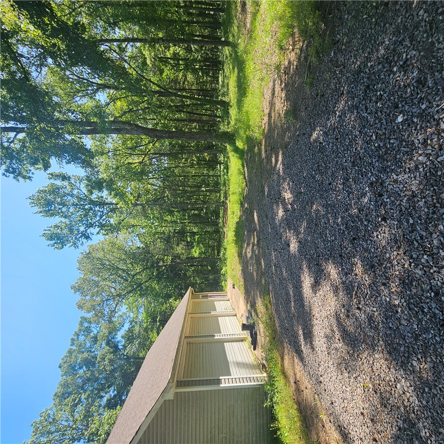 Open and spacious woodland with a large shop has endless possibilities.  
Find the perfect mix of open spaces and natural beauty on this quiet piece of property. Whether you're looking for a home site, hobby farm or a place to have a business, this place offers flexibility and room to grow. 
The land has been opened while still maintaining a wooded backdrop for privacy and shade, ideal for building, recreation or simply enjoying the outdoors.  A standout feature is the large shop, (1200 sqft) building with three bay doors.  Perfect for storage, equipment, workshop or even a small business setup.  With easy access and usable acreage this property is ready for your vision.