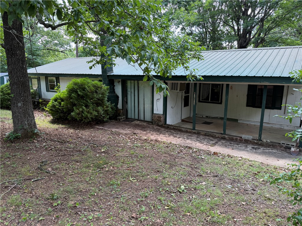 Tucked away on two peaceful acres just outside of Compton, Arkansas, this two-bedroom, one-bath fixer-upper is brimming with possibility. Nestled in the heart of the Ozarks with Buffalo National River country practically at your doorstep and the Center Point Trailhead just down the road, this property offers the kind of location that outdoor lovers dream about. The metal roof appears to be in solid shape — a great head start on what could become a charming weekend getaway cabin, a profitable VRBO retreat, or the foundation of a small cabin rental development. Imagine a handful of cozy cabins dotting these quiet, wooded acres, each one booked solid with hikers, paddlers, and nature seekers year-round. One of the most enchanting features of this land is its old homestead spring and the remnants of a historic springhouse — a rare piece of Ozarks heritage that lends authentic character you simply can't manufacture.