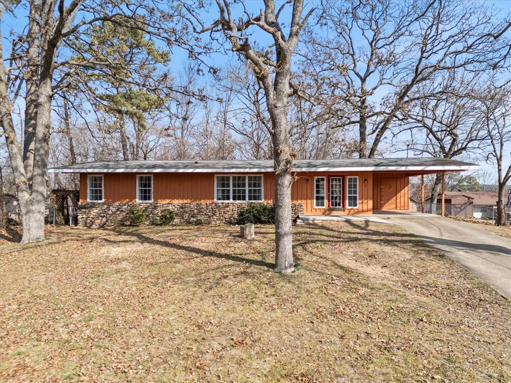 Looking for a potential Airbnb or a starter home just minutes away from Tunnel Vision Trail? This bright and inviting 2-bedroom, 2-bath home offers 1344 square feet of well-designed living space, featuring attractive built-in shelving around the front entry and in the kitchen.  Both bathrooms have been updated, and the stove, refrigerator, washer and dryer convey with the home. Enjoy the spacious front and back yards, perfect for relaxing or entertaining.  A backyard shed-currently used for bike storage, provides additional storage space, along with extra storage in the carport. Home has newer 1,000-gallon septic tank and a newer reverse osmosis water system. Newer concrete steps and patio in the back yard.