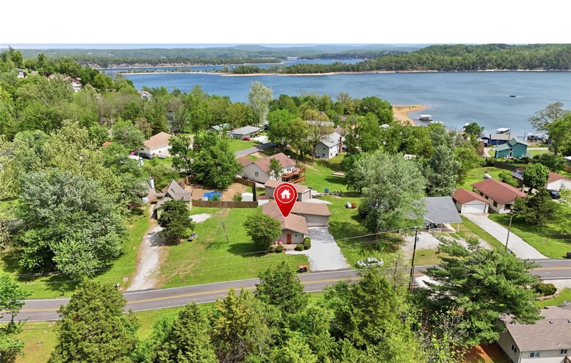 This Beaver Lake property has it all! A fully furnished home, lake view, turnkey Airbnb/Vrbo business, paved roads all the way to the home, 3 nearby boat launches with swim/beach areas, and minutes to downtown Rogers. Property is also offered with a boat slip and hot tub – see ML #1343929. Perfect for a family lake home, investment property, or both. The home is currently used as a short-term rental and has exceptional reviews on Airbnb/Vrbo and substantial income potential. Everything is practically new after a complete remodel down to the foundation in 2018 and a new Class 4 hail-resistant roof with lifetime warranty is coming soon. All rooms are on the main level except the laundry room. The 16'x40' detached garage with 9' tall door offers ample storage for trailers, boats, jet skis, ATVs/UTVs, etc. Only 2 minutes to a community boat launch with swim/beach area, 9 minutes to Prairie Creek Marina, and 14 minutes to downtown Rogers. See ML #1343929 for listing with boat slip and hot tub.