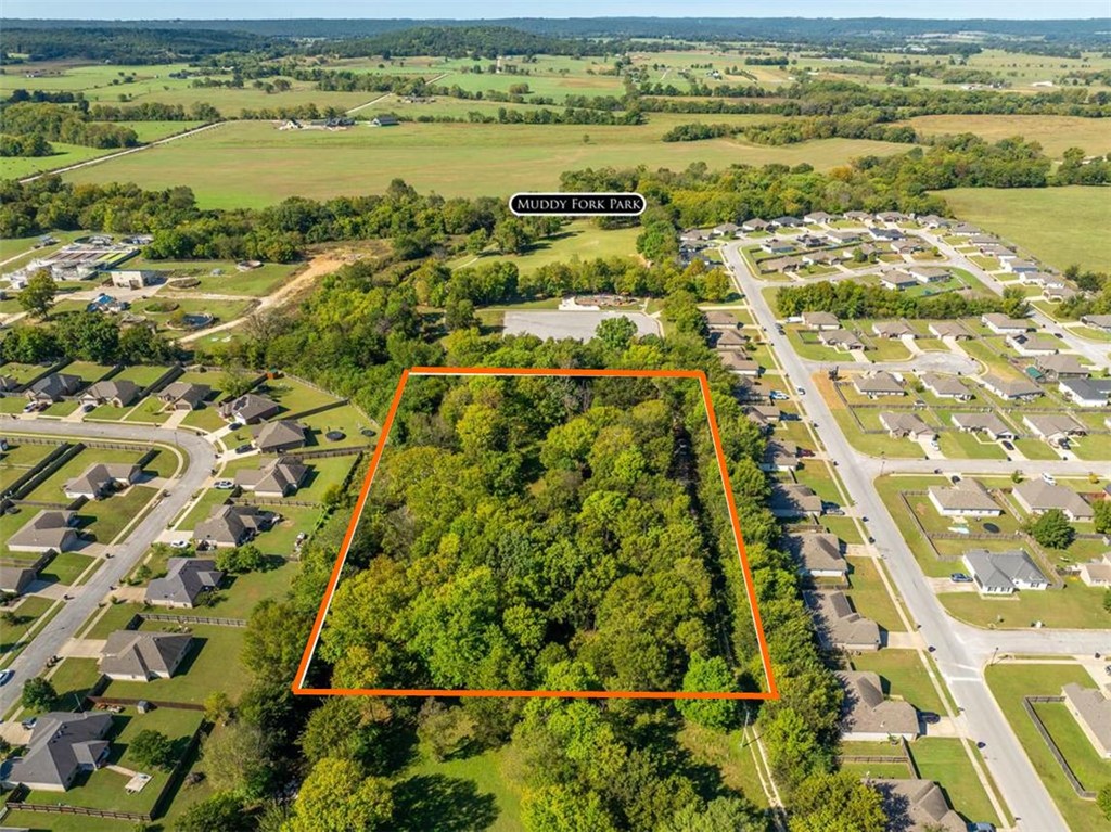 4 acres m.o.l. property located near nice subdivisions right in the city of Prairie Grove. Muddy Fork Park is right next door with playground, dog park, and walking trail. Great spot for an estate home or subdivide as you wish or possibly convert to multi family. 2 septic systems, electric, and public water are all on site. There is an existing mobile home on the site that can be removed or possibly live in while building. The mobile conveys "AS IS". The possibilities are nearly endless with this property. Call us today for a showing or particulars.