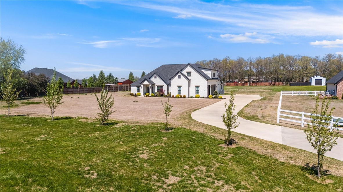 NEW LOWER PRICE!! Nestled on an expansive 1.75 acres just 5 minutes from I-49/Elm Springs in Springdale, this stunning residence offers the perfect blend of luxury, comfort, and wide-open space. Boasting 3 spacious bedrooms & 3.5 beautifully appointed bathrooms, this home features an open floor plan designed for entertaining. The heart of the home is the kitchen, flowing seamlessly into the living and dining areas, all enhanced by a built-in Sonos sound system that extends to the patio—ideal for gatherings large and small. A chef’s dream, the oversized butler’s pantry includes an ice-maker and beverage refrigerator, offering both functionality and convenience. Upstairs, an oversized bonus room with full bath offers endless possibilities—perfect as a media room, guest suite, home office, or playroom. Whether hosting elegant dinner parties, casual game nights, or enjoying a peaceful evening on the patio, this home was built for entertaining. With unmatched acreage & high-end details throughout, a rare gem in NWA.