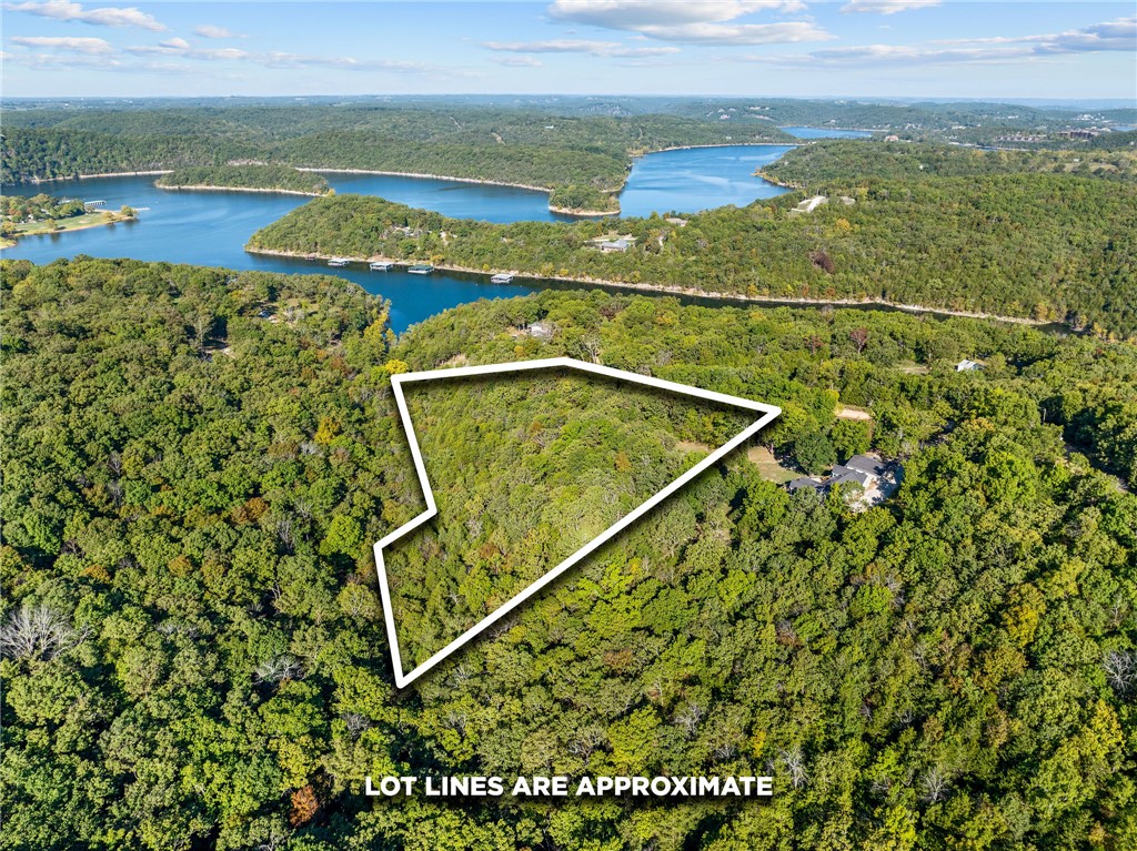 **LAKE-VIEW DEVELOPMENT OPPORTUNITY | 6.71 ACRES | NO HOA | NO RESTRICTIONS** Exceptional investment opportunity in the heart of the Ozarks! This 6.71-acre lake-view property offers outstanding potential for a luxury cabin community, short-term rental development, private estate, or vacation retreat. With no HOA and no restrictions, you have the freedom to build and develop to fit your vision. Located less than 2 miles from Cricket Creek Marina and just minutes from Big Cedar Lodge, Top of the Rock, Thunder Ridge Nature Arena, and Branson's attractions, this prime location is ideal for vacation rentals with strong year-round demand. Enjoy scenic lake views, easy lake access, and endless possibilities in one of the Ozarks' most desirable vacation markets. Rare unrestricted acreage like this is hard to find—don't miss this exceptional investment opportunity.