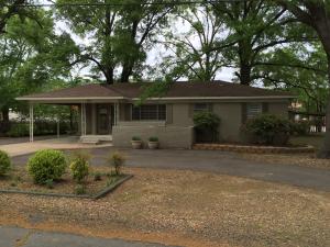 Enjoy the tree covered lot on this nice home in West Russellville.  Living room, 3 beds, and 1 1/2 baths.  Hardwood floors in living and bedrooms.  Dining area with built-ins.  Laundry with drying rack.  Deck.  Carport plus detached garage with storage.  Circle drive.