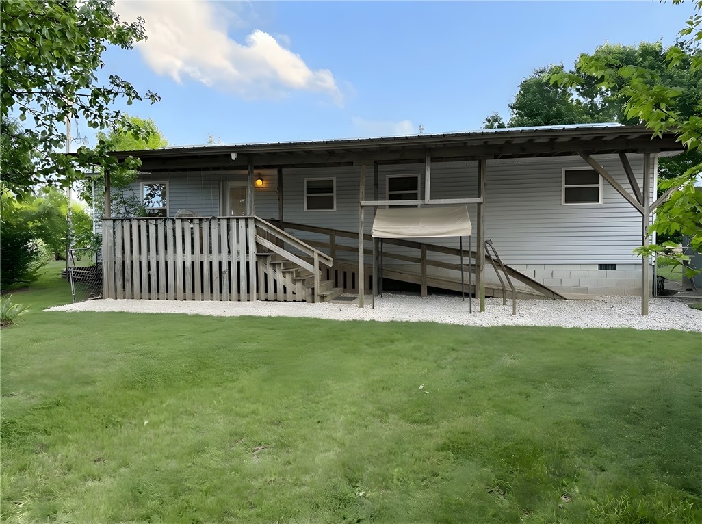 Reserve Auction being held at this property on May 9th, 2026 at 10 AM. Successful bidder will be required to pay $25,000 (cash or cashier’s check) down payment and sign a real estate contract at auction to close within 30 days of auction. Buyer will be credited at closing. 
Located in a highly desirable area, this well-maintained home offers peaceful country living with great functionality on 4+ acres. Features include a versatile garage/shop, spacious barn for livestock, and multiple fenced pastures ideal for agricultural or recreational use. Mature shade trees create a serene setting, while an accessible ramp provides easy entry from driveway to the front porch. Surrounded by attractive homes, this property is ready to be transformed into your ideal showplace.