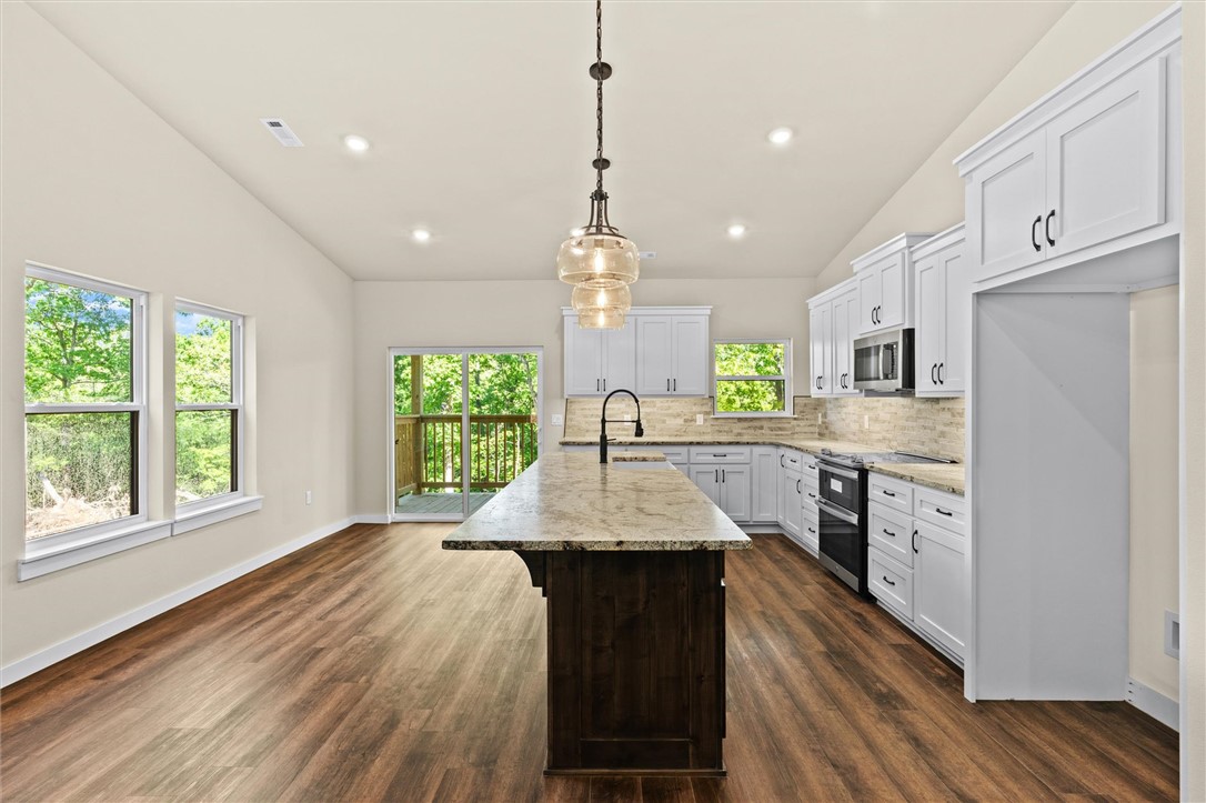 Experience elevated country living on 3.45 beautiful acres with an oversized 3-bay garage — two standout features that are hard to find together. Located near Withrow Springs State Park and minutes from hiking trails and outdoor recreation, this stunning new construction home offers the perfect blend of privacy, space, and luxury finishes. Thoughtfully designed with upgraded lighting, premium appliances, and gorgeous Pella sliding glass doors that fill the home with natural light and showcase the surrounding scenery. The spacious layout includes a stunning primary suite with an en suite bath and oversized walk-in shower. Step outside onto the back deck and enjoy peaceful country views with plenty of room to roam, entertain, or relax in the quiet setting. The oversized 3-bay garage offers incredible space for vehicles, boats, workshop space, and all your outdoor gear. Another bonus- the electrical panel is pre wired for a generator! This one checks every box!