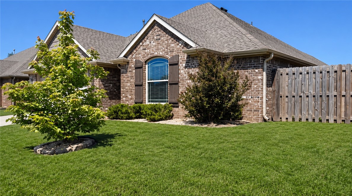 Home is in a great location, close to everything at Pleasant Grove besides being close to Downtown Rogers, ball parks and schools.  Great split bedroom floor plan, 2 BR's in front and primary BR on the backside of home.  Large 2nd bath with open entry way.  Breakfast Bar and island in kitchen with lots of counter space.  Has a pantry in Kitchen and large Eat-in-kitchen area that looks out thru sliding glass doors to your covered patio.  Great for entertaining and grilling for friends and family.  Gas log fireplace with mantle.  Primary Bedroom is off of the LR, large bathroom with double vanity's and dressing table. 
Has nice walk-in-closet, and a walk-in-shower with a whirlpool tub.  All brick on the exterior and gutters all around the home.  This home will not last long so book a tour today.