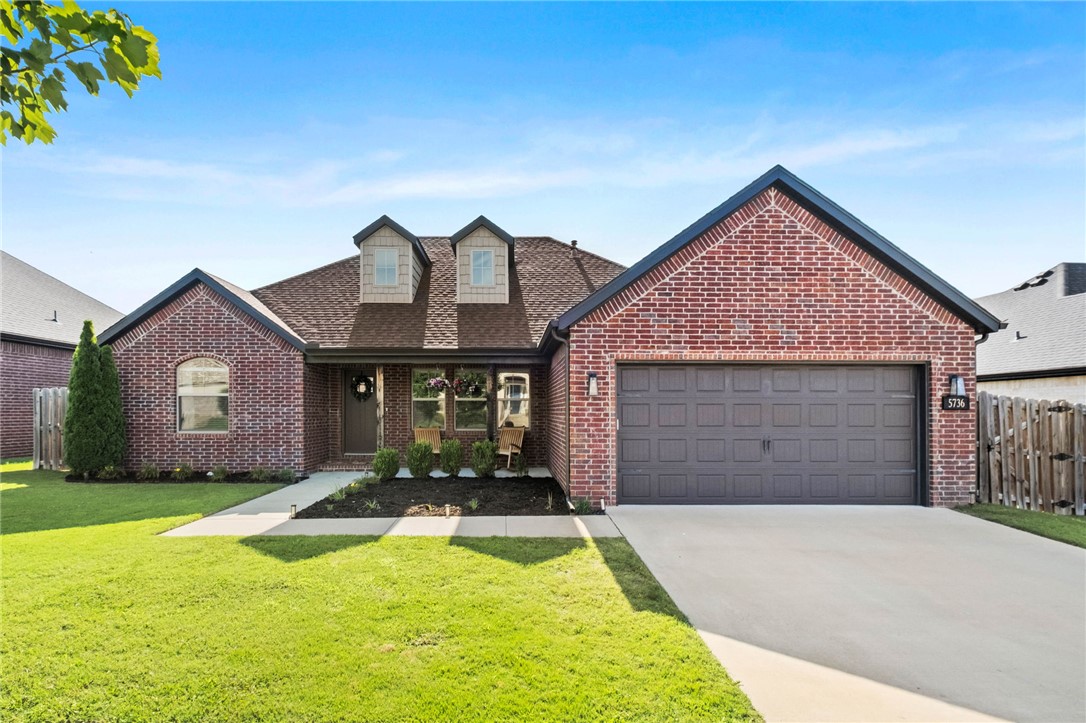 Welcome home to this charming single-level, all-brick home in Legacy Pointe! Just 10 minutes from the University of Arkansas and everything Fayetteville has to offer, this 3-bedroom, 2-bath home blends character, comfort, and convenience. The split floor plan features a spacious living room with a double-sided fireplace that opens to the large eat-in kitchen, creating the perfect space for entertaining. Gorgeous windows fill the home with natural light, while wood beams add warmth and timeless character. The kitchen offers granite countertops, bar seating, abundant cabinetry, and a gas range. The private primary suite includes a jacuzzi tub, walk-in tile shower, dual vanities, and a large walk-in closet. You'll also love the oversized laundry room with a built-in coffee bar! Outside, enjoy a covered patio and a flat backyard that's perfect for kids, pets, or backyard gatherings. Storage shed to convey. 1% preferred lender credit available with Benchmark Home Loans!