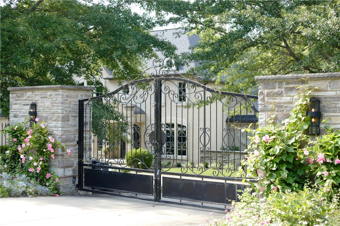 A rare private estate in the heart of Fayetteville, this custom-built residence offers the space, seclusion, and substance that are increasingly difficult to find close to town. Set on 3.27 secluded acres with a guest house, heated gunite pool, outdoor kitchen, creek frontage, and no binding HOA, the property is a private retreat while remaining minutes from everyday convenience.  Inside, generous living spaces, substantial finishes, a private office/library, media room, wine cellar, playroom, and multiple bedroom suites allow the house to live comfortably while also accommodating guests, nanny or multigenerational living.  Thoughtfully simplified grounds for everyday enjoyment, with mature trees, open lawn, outdoor gathering areas, and exceptional privacy. A gated estate with a sense of seclusion, while wooded acreage behind the property creates a natural backdrop rarely available so close to Fayetteville. A property for someone who values privacy, quality, land, and a home with true presence.