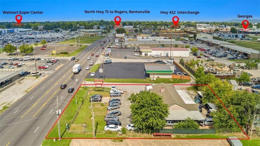 Prime Location on Highway 71! High visibility area across from Tyson offices and walmart, less than a
mile from the Highway 412 intersection! Large flat lot with multi car parking, outside storage, and a
useful building. Current tenant has an automotive sales business, previous owner had a flea market, the
city also approved a mulit unit building opportunity. Buyer to determine if their desired usage is
approved. Springdale is home to several large industries accessed by highway 71. Highway 71 is the
original gate way to NWA and still sees more than 26000 cars per day in front of this building.
