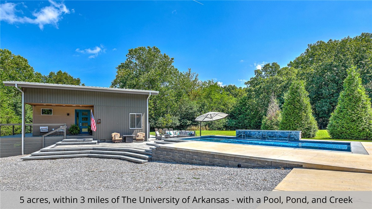 This property is a golden opportunity you don’t want to pass you by! This contemporary home is within 3-miles of the U of A, offering a secluded and peaceful setting on 5 expansive acres. With a scenic pond and creek as your backdrop, you’ll have the perfect place for relaxation. The newly added heated, in-ground pool (2023) includes a hot tub, fire feature, and a waterfall for a winning finish. Inside, you’ll be greeted with an open living and kitchen area with cathedral ceilings adding to the wow factor. Furthermore, this smart home is equipped with a media room and speakers throughout, ensuring you’re always in the zone. Don’t miss out on this standout property!