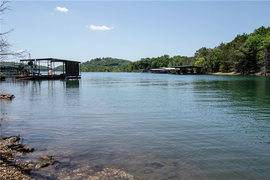 Turnkey Beaver Lake waterfront retreat with proven Airbnb income! Nestled in a protected cove in Lost Bridge Village, this fully furnished home offers direct water access, beautiful lake views, spacious indoor/outdoor living areas, and a successful short-term rental history. Whether enjoying coffee on the deck at sunrise or evenings around the fire pit after a day on the water, every detail invites you to slow down and enjoy lake life. Perfect as a vacation getaway, investment property, or full-time lake home. Enjoy kayaking, swimming, fishing, and relaxing just steps from your backyard. Conveniently located near Lost Bridge Marina, dining, and recreation. Move-in and rental-ready. Call for your private showing.