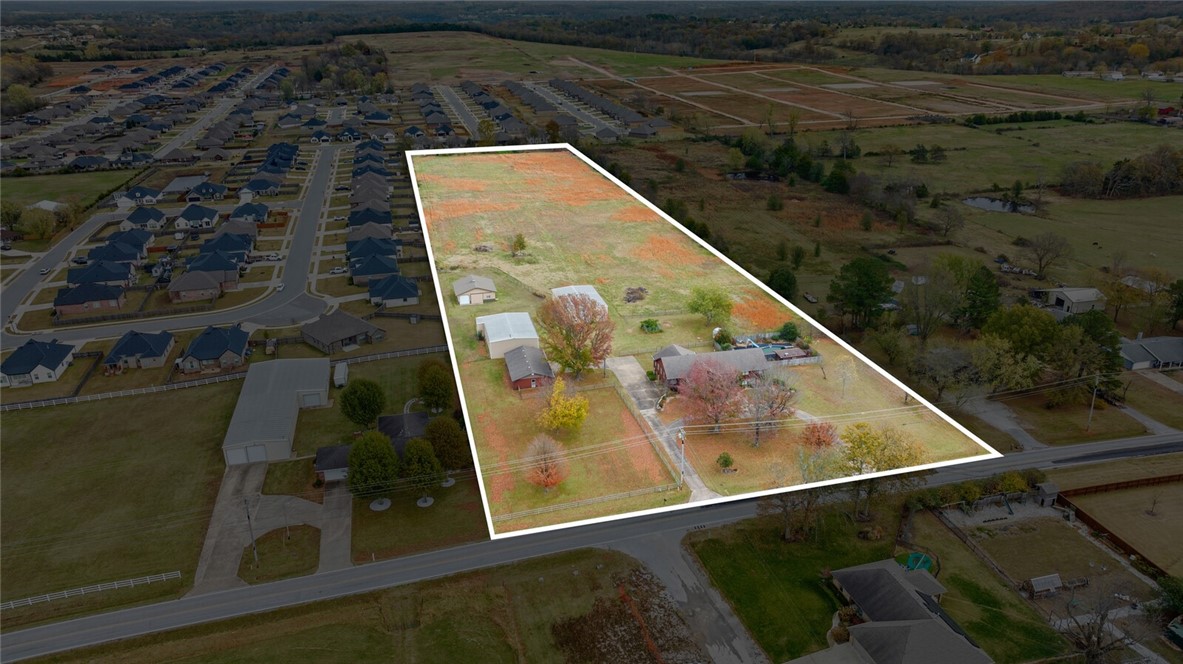 Incredible opportunity to own 10.05 acres with development potential that fronts soon to be 5 lane Butterfield Coach Road. This 10.05 flat acres features 40 X 60 insulated barn/shop with electric + heater and 3 garage bays, another 40 X 60 insulated barn/shop with electric and 2 garage bays, 28 x 50 building with electric and 3 garage bays with additional finished out workspace/room with sink, and 36 x 36 2 stall horse stable and tack room & garage bay. Additionally the property has a 3,564 sq ft 3 bedroom, 3 bathroom split level home with an in ground pool and pool house with kitchenette and half bathroom. Property is sold “As Is.”