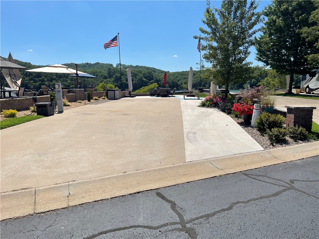 Mesmerizing Long Lake views with this gorgeous water front lot! Table Rock Lake sunsets create memories of a life time and the fishing is some of the best we have in the Ozarks. This level landscaped lot offers a wide RV space, Multitude of electrical outlets, a full outdoor kitchen complete with Large cantilever umbrella and several pieces of patio furniture for entertaining. You'll love the additional green space and the mature shade tree offered out the picture window and say hello to unobstructed views! Welcome to the Lake ** This Lot is in the rental pool. Please do not disturb the guests