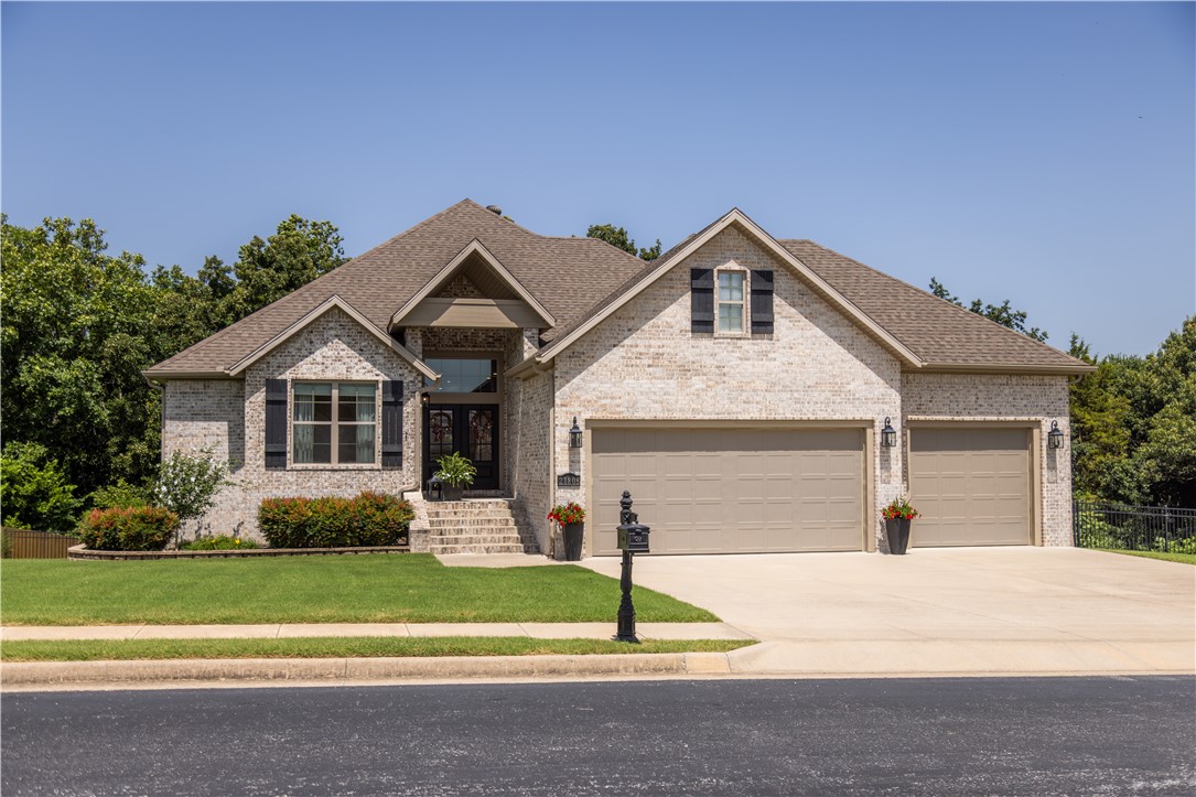 Enjoy Beaver Lake area living in this move-in ready home on 1+ acres in a neighborhood featuring shoreline boat launch and adjacent walking trails. This property extends beyond the rear fence line creating a wooded backdrop, plus beautiful views of rolling hills from the front yard. Designed for comfort and entertaining, the main level offers an open living, kitchen, and dining, along with built-in office, mudroom, utility, half bath, 3-car garage, screened-in porch and side patio to take in the natural surroundings. Upstairs also features primary suite bed & bath, plus guest bedroom with en suite bath. The walkout basement adds second living area with wet bar, play space under the stairs, 2 additional bedrooms, 1.5 bathrooms and generous flex space not included in the heated square footage, which has partially finished area currently used as a home gym and extensive unfinished storage. Step directly outside from the basement to a covered patio with a built-in grill & huge yard perfect for gatherings and gardening.