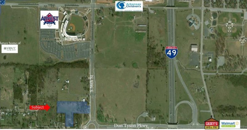Look at the commercial/development potential on this 5+/- acres! Double entrance. Land goes around and reconnects to Don Tyson Pkwy. Great proximity to Arvest Ballpark, Children's Hospital and I-49. Commercial utilities already on property - sewer, water and electric. Level. Can be re-zoned commercial upon ownership.