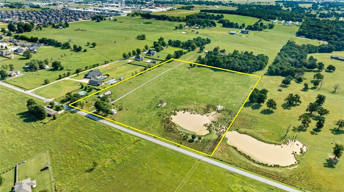 Back on market!  13.5+/- acres of open land in prime Tontitown area. Two sets of gas, electric and water are available on the property (one near the mobile home and one where the existing storm shelter is near the driveway).