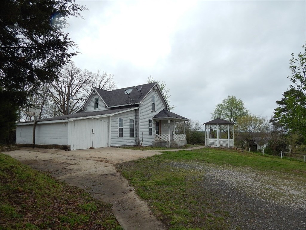 Home on 0.77 acres with 2bed/2bath and a room that could be used for 3rd bedroom. New ch/a, paint, carpet, and gas stove. 1210 total sq ft, built in 1898, bedroom and bathroom upstairs 288 sq ft,  922 sq ft downstairs. old well house. Rural water and natural gas. 10x10 outbuilding for storage. Garage unfinished 242 sq ft. Hwy frontage. Approx 30 mins m/l  to Springdale or Fayetteville.