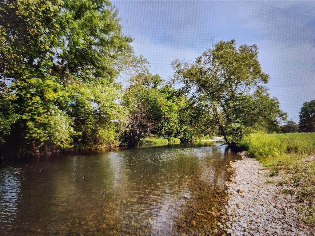 Spectacular building site in the coveted Little Osage Valley on Mill Dam road. The POA boasts 22+/- acres of common area for recreation on the Little Osage. The common area is great for fishing, swimming, tubing with the kids, or a glass of tea and a hammock. Build your dream home here and enjoy surrounding nature and space to play. This is an excellent neighborhood near XNA airport but only 10 minutes from Bentonville. There is a 2,500/sqft minimum. See attached covenants and restrictions. Bentonville School District. Buyer to verifies utilities. Back portion of lot is in flood plain (as it backs right up to the creek).