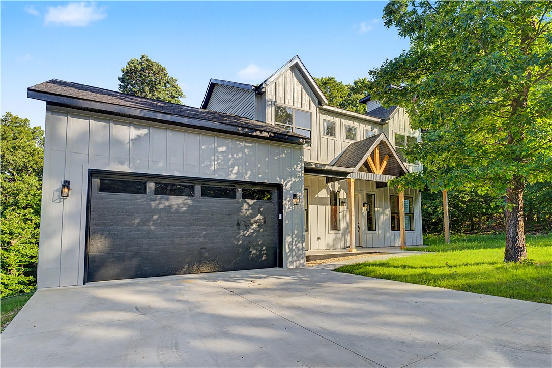 Tucked away among the trees in Bella Vista, this stunning new build blends modern farmhouse style with total privacy. Inside, the open-concept design centers around a bright, spacious living area with a fireplace, flowing effortlessly into the kitchen and dining spaces — perfect for everyday living and entertaining alike. Step out onto the elevated back deck and take in tranquil views of the natural ravine, an ideal spot to unwind at the end of the day. Rounding out the home are a 2-car garage and thoughtfully chosen finishes throughout, all just minutes from Bella Vista's trails, lakes, golf courses, and other top amenities.

$4,000 SELLER-PAID CLOSING COST CREDIT WITH ACCEPTABLE OFFER

Note: Property perc was approved for a 2-bedroom design.