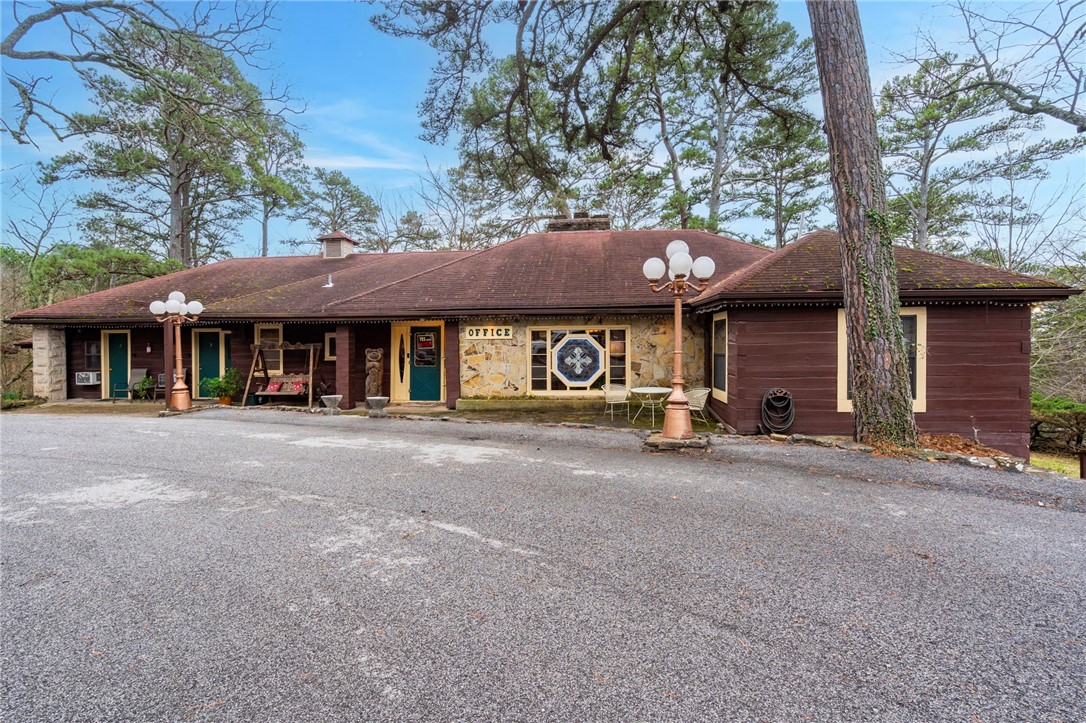Welcome to Brackenridge Lodge, a historic retreat comprising of 12 rentable rooms, cabins, or suites, offering modern comforts like jacuzzi tubs, kitchenettes, and flat-screen TVs. 5 rooms boast cozy fireplaces for added warmth and ambiance. Brackenridge Lodges’ main house is a beautifully maintained 1940s oak log cabin with 3 fireplaces, 2 bedrooms, 2 full and 2 half bathrooms. The fully finished basement, complete with a workshop/safe room, provides additional space for relaxation or as an extra bedroom. Whether you choose to reside on-site, provide accommodation for employees, or rent out this charming home to guests, the possibilities are endless. After a day of exploring, guests can unwind by the inviting inground pool or soak in the breathtaking views of the Ozarks from the patio. Located off Hwy 62 and approx. 1 mile from Historic Downtown Eureka Springs, Brackenridge Lodge enjoys prime positioning. Plus, being the site of Trolley Stop #121 ensures easy access to all that Eureka Springs has to offer!