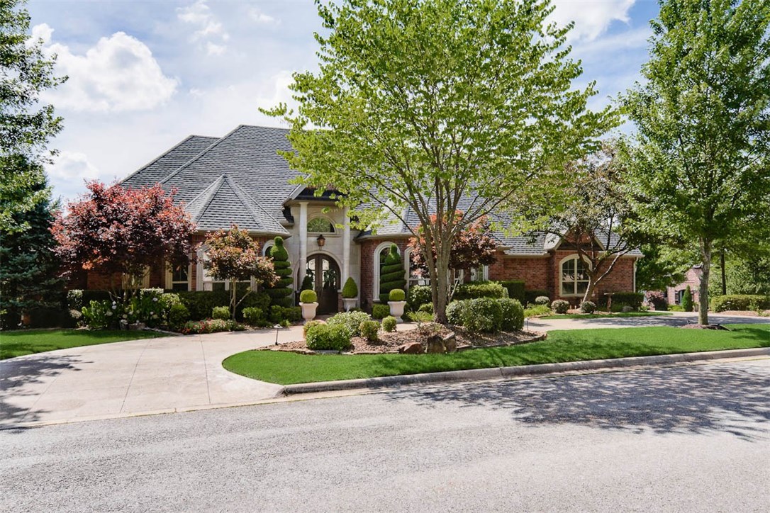 Exquisite, elegant home located on a corner lot in Pinnacle Country Club. Circle drive with side load, oversized 3 car garage, mature landscaping/trees and a stunning, covered outdoor patio with built-in wood-burning fireplace, outdoor kitchen and in-ground pool/spa with waterfall. This incredible floor plan offers 4 bedroom suites on main level and spacious bonus room (or 5th bedroom) with full bath on second level. Each room offers intricate design details, arched openings, custom built-ins and home has been recently updated with NEW bathroom remodels, paint, lighting, flooring, etc. Located in Bentonville school district. ***11x14 workshop with built-ins located in the garage (heated and cooled)is not included in square footage.***