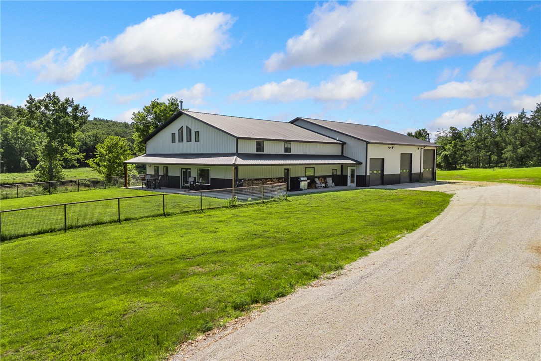 Custom-built in 2023, this barndominium offers 3,946 sqft of living space and a 3,600 sqft insulated, heated/cooled shop on 25 level acres with 265+ ft of West Sugarloaf Creek frontage. Features include soaring ceilings, abundant natural light, LVP flooring, a chef's kitchen with quartz countertops, oversized island, shaker cabinetry, and butler's pantry. The spacious layout includes 4 bedrooms and 3 baths, including a private primary suite with dual closets. Upgrades include multiple HVAC systems, gas fireplace, Vermont Castings wood stove, tankless water heater, whole-home water treatment, reverse osmosis system, private well, septic, propane tank, generator wiring, Eero Mesh Wi-Fi, and SONOS audio. The climate-controlled shop offers large doors, pull-through access, and RV hookup. Additional improvements include power blackout blinds, metal fencing, chip-seal driveway, and gutters. Minutes from Bull Shoals Lake. Inquire for detailed update list.