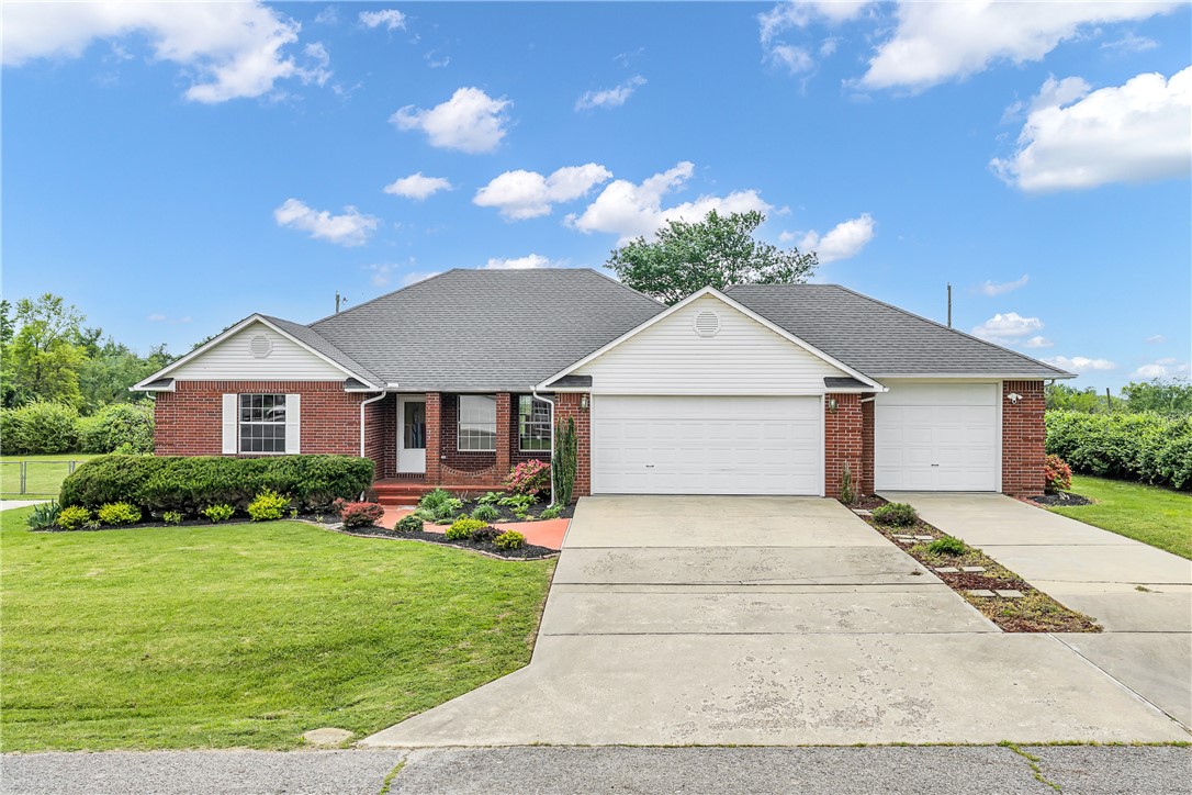 If you've been searching for a solid, move-in-ready home in Rogers with room for everyone — this is the one to see. This well-maintained 4-bedroom, 2-bath ranch in Hancock Sub sits on a level third-acre lot and checks nearly every box. The split floor plan gives the primary suite its own private retreat, while three additional bedrooms offer flexibility for family, guests, or a home office. The eat-in kitchen features granite counters, a glass cooktop, and a full appliance package — ready for real life from day one. A cozy gas fireplace anchors the living room, and the walk-in closets throughout make storage a non-issue. Outside, you'll love the oversized 3-car garage with workshop space, plus a separate storage building. All of this in a prime Rogers location — close to top schools and shopping, with easy freeway access. Classic brick exterior, architectural shingle roof, and a deck out back round it out perfectly.