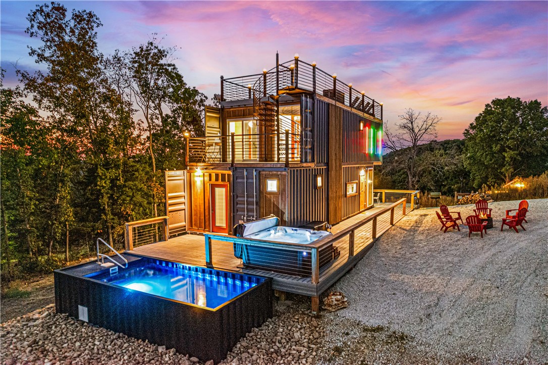 Unique Turn Key short term rental investment on Table Rock Lake with 50% owner financing available. This custom built luxury container home features a heated container pool, hot tub, composite decking and a rooftop deck with incredible lake views. Located next to Cricket Creek Marina, you and your guests can be on the water in moments. 10 minutes from Top of the Rock, Big Cedar and Thunder Ridge Amphitheater. 20 minutes from Branson. No HOA. Some of the lowest property taxes in the Branson area. Full service management in place or you can self manage for maximum ROI. The home is being sold furnished and turn key. Booking reports available upon request. Gross revenue in 2025 was $95k. Adjacent lot may also be available, offering the opportunity to build an additional home.  Listing agent is a member of the LLC that owns the property. airbnb.com/h/bransoncontainerhome